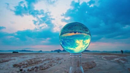 Wall Mural - time lapse view of The moving clouds obscure the setting sun inside crystal ball. the sun moving down to the islands at Tubkaek beach Krabi. Nature High quality footage in nature and travel concept.