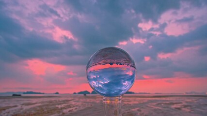 Wall Mural - time lapse view of colorful nature at sunset inside crystal balls.
beautiful cloud in sky over sea in a crystal ball on the beach. 
Nature High quality footage in nature and travel concept.