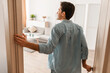 © Prostock-studio - Rear back view of excited young man walking in his apartment, entering new home, happy young guy standing in doorway of modern flat, looking at design interior, coming inside, selective focus