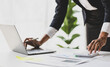 © Wasan - Businesswoman working with financial documents in the office is calculating income, expenses and planning a budget, Analyzing financial statistics in business reports.