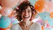 © Vuvimages - A smiling woman with short hair is seen amongst an array of colorful balloons, celebrating in a vibrant and festive environment filled with confetti and joy.