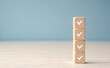 © Celt Studio - four wooden cubes marked tick check completed tasks. concept of organization, sequential task execution, and productivity. project management, goal achievement, and business efficiency visuals