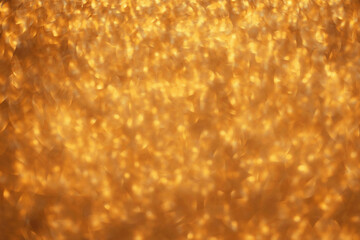 Golden glitter festive bokeh background, abstract defocused texture. Holiday lights