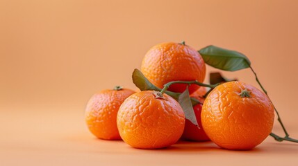 Wall Mural - light orange background with an arrangement of tangerines