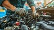 ©  Abby Photo - Mechanic repairing a car engine with power tools in an auto repair shop