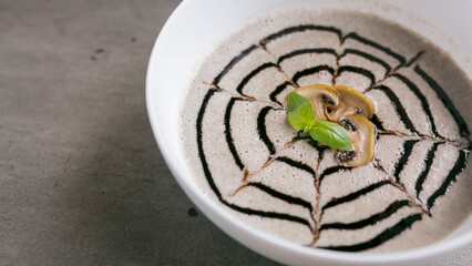 mushroom soup puree in a white plate, large photo