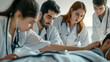 © alfa27 - A group of doctors are gathered around a patient