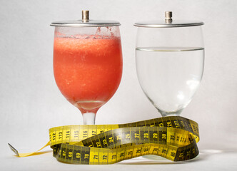 Fresh melon juice and water with measuring tape : diet concept