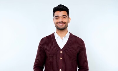 Wall Mural - portrait of a Mexican man in his 30s wearing a chic cardigan against a white background