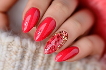 perfect almond shaped manicure ether nails are bedazzled with red garnate crystals and gold for Christmas holidays