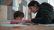 © Marco - Parent and child working together on educational activities, showing collaboration and dedication to learning in a supportive and nurturing home environment