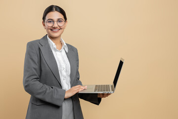Smiling woman in formal wear using laptop for office work