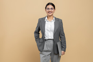 Pretty woman in formal wear holding laptop copy space for promotion