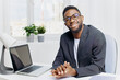 © SHOTPRIME STUDIO - Confident african american businessman in a suit working on a laptop at his office desk, focused and professional