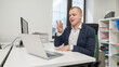 © Михаил Решетников - Caucasian deaf man talking sign language over video call on laptop in office.