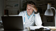 © Krakenimages.com - Tired hispanic male doctor in lab coat working late in the hospital office with laptop and paperwork