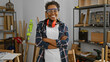 © Krakenimages.com - Confident woman with safety glasses and earmuffs stands crossed-armed in a carpentry workshop.