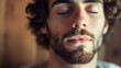 © Natali - Man with closed eyes enjoying a moment of calm and relaxation. Close-up portrait capturing tranquility and peace