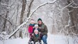 © Felippe Lopes - A father and his three children smile for the camera in a snowy forest.
