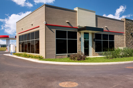 modern building with a large glass facade and a beige brick base. the architectural design suggests 