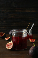 Sticker - Figs and jars of jam on wooden background