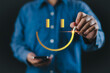 © Nirusmee - Customer review satisfaction feedback survey concept. Man using a pen to draw happy smiling face on a virtual screen. Service product evaluation business, Positive thinking, Mental health assessment,