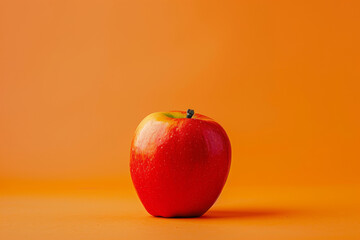 Wall Mural - red apple on a oringe background