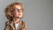 © Pixel Mind - A young child with curly hair wearing glasses looks confidently while posing indoors