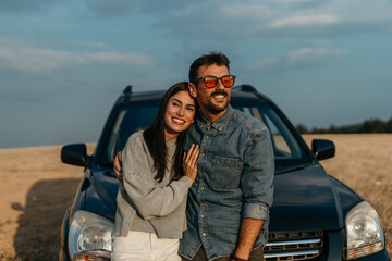 Shot of a young couple stopping to look at the view while on a road trip