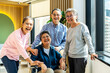 © TeTe Song - Group of asia happy retired senior people enjoy standing relax at hospital, portrait of asian senior male female friend group sit of wheelchair smiling together and look at camera