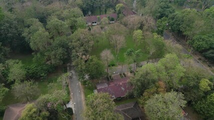 Poster - Aerial view of residential neighborhood roofs with nature forest trees. Urban housing development from above. Top view. Real estate in Bangkok City, Thailand. Local property real estate