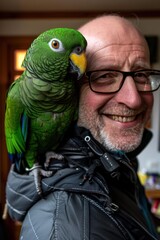 Wall Mural - A man smiles as a parrot sits on his shoulder. AI.