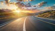 © poomrapee - Scenic highway winding through mountain landscape during a stunning sunset with colorful clouds and warm golden light.