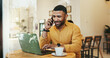 © PeakPoints/peopleimages.com - Man, cafe and laptop on phone call for with remote work as business consultant with communication. Entrepreneur, freelancer and browsing website for research or networking for project at coffee shop