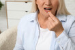© Pixel-Shot - Beautiful mature woman taking pill at home
