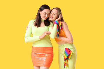 Sticker - Beautiful young lesbian couple with LGBT flags on yellow background