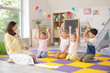 © Pixel-Shot - Little children with nursery teacher studying letters in kindergarten