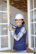 © auremar - portrait of young woman measuring window