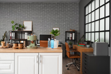 Wall Mural - Coffee machine with cups and water bottles on counter in office