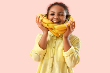 Sticker - Little African-American girl with bananas on pink background