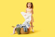 © Pixel-Shot - Shocked little girl with dirty laundry on yellow background