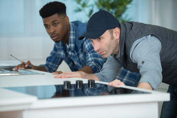 two men fitting a new kitchen