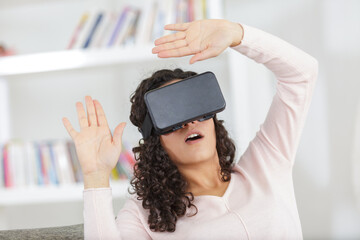 Wall Mural - scared woman using virtual reality mask