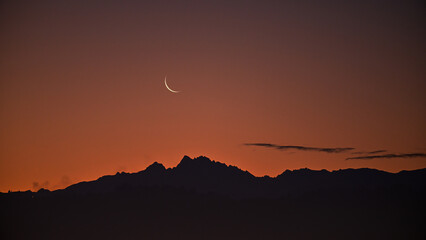 gorgeous moutain view at sunset with moon in the sky