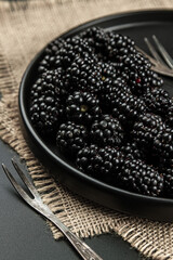 Wall Mural - Blackberries on a black background. Ripe berries