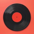 © NiponTK - Vintage black vinyl record on a vibrant red background, perfect for music and retro-themed designs.
