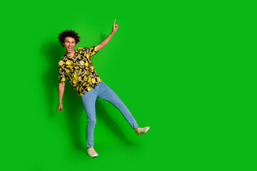 Sticker - Photo of funny optimistic man clubber wear stylish clothes dance empty space isolated on green color background