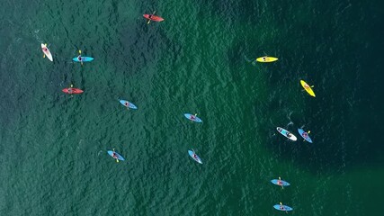 Wall Mural - Aerial view to a group of people with kayaks in the sea
