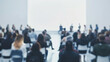 © JMarques - People in a meeting or conference with a blank screen. Audience or public paying attention at a seminar, business people gathered together, blurry, unrecognizable, copy space.