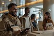 © Milos - A group of young professionals are enthusiastically networking and using tablets at a conference, symbolizing collaboration, modern technology, and career growth in a stylish venue.